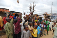 John Umaru, Carter Center expert, asks children in the Nasarawa North community to raise their hands if they have blood in their urine.