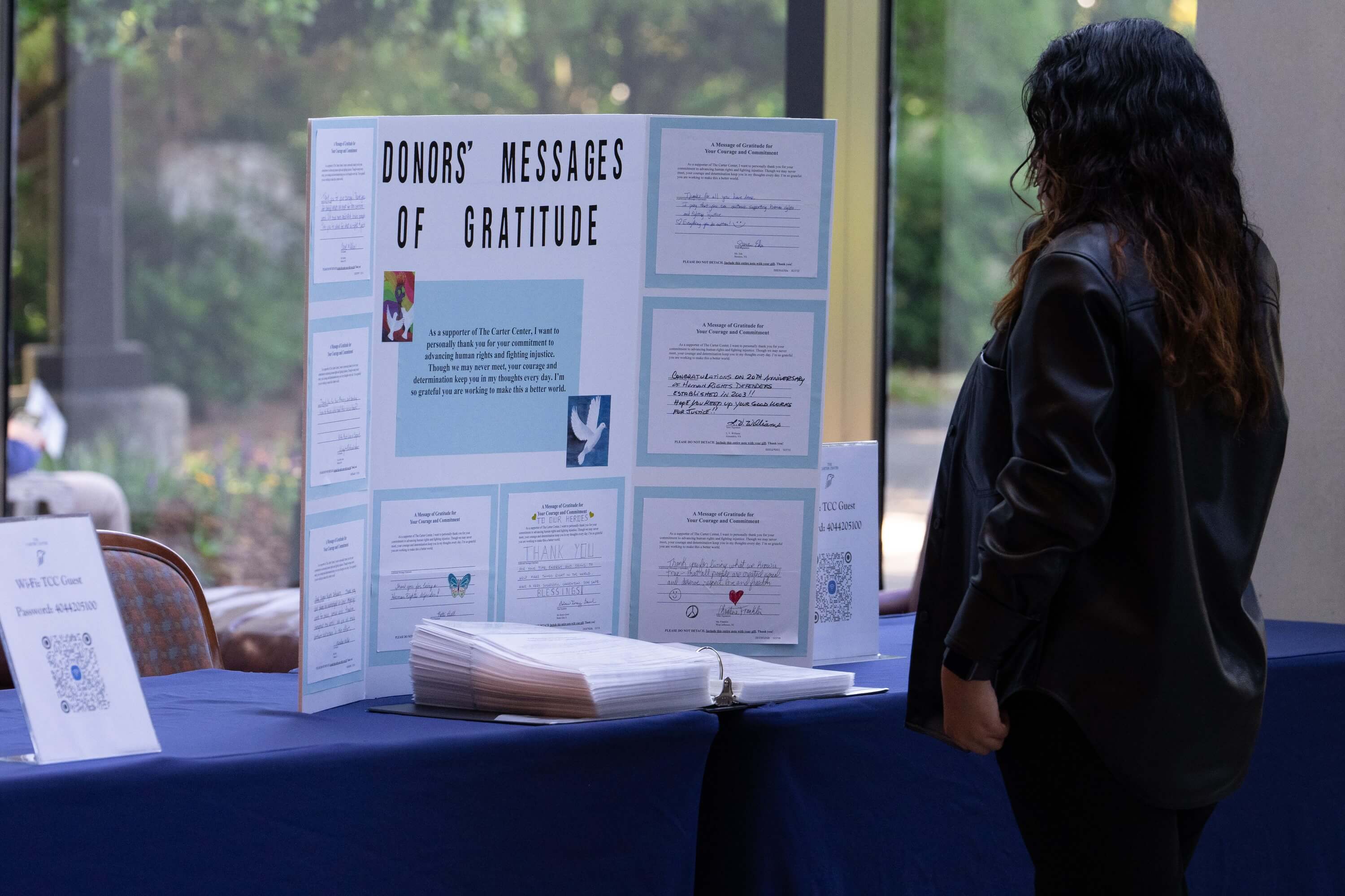 A women looks at a poster. 