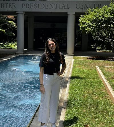 Lela Boys-Sibley standing in front of the Carter Presidential Center