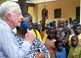 Former U.S. President Jimmy Carter addresses Ghanaian children outside Savelugu Hospital, asking 