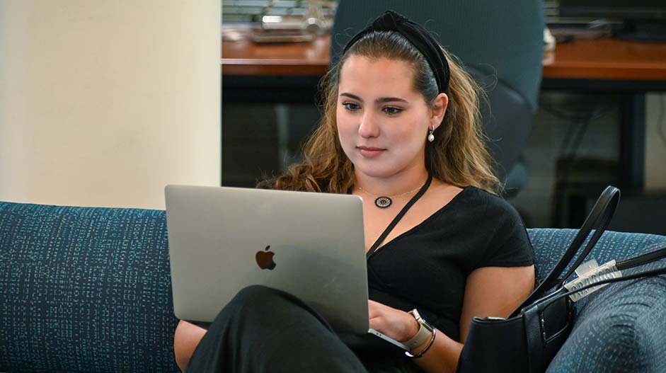 An intern working on a laptop.