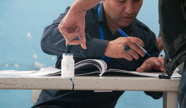 A voter dips his finger in indelible ink. The ink got a little messy at times, as this was a new thing for many people and they weren't sure how much to dip.